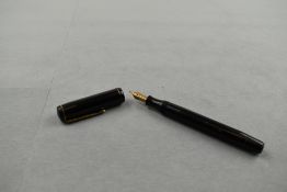 A Mentmore Supreme button fill fountain pen in black having single band to the cap with Mentmore