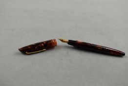 A Gold Starry piston fill fountain pen in red/pink marble with single band to the cap having Nox 2