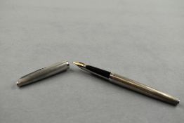 A Waterman C/F cartridge/converter in silver having 18k nib. Approx 13.5cm