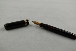 A Soennecken 120 piston fill fountain pen in black with three bands to the cap (clip missing) having