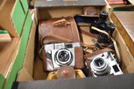 Two vintage cameras, and Agfa and a Yoightlander, and a set of binoculars.