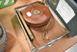 A vintage folding box wood rule and a tape measure.