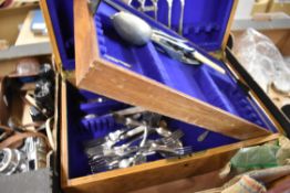 An oak cased canteen,around 1930s having a mixed collection of cutlery inside including bone handled