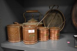 A selection of copper kitchen wares including graduated corn scoop
