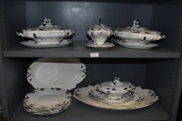 An antique part dinner service having blue and white design including tureens charger etc