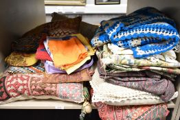 A selection of retro textiles and fabrics including crotchet blankets and table cloths