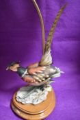 A modern figural lamp base with male pheasant