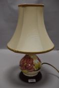 A modern Moorcroft pottery hibiscus pattern table or side lamp with cream ground