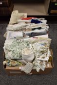 A selection of fabrics and textiles including lace work and printed sheets