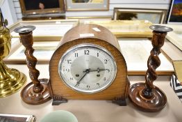 A pair of oak barley twist stem candle sticks with an Art Deco Anvil clock