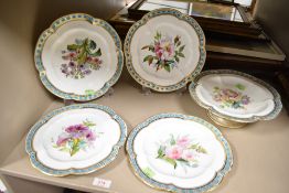 A set of four Victorian hand painted plates and a footed tazza all decorated with flowers in blue
