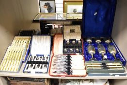 A selection of cased sets of cutlery and flatwares including cocktail spoons, butter knives and