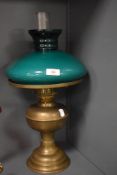 A library style oil lamp having brass base with emerald green shade