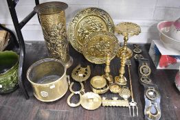 A selection of brass wares including stick stand, candle sticks, trivet and plates etc