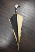 An Art Deco umbrella or parasol in black and white with a duck head handle