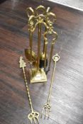 A brass fire side companion set with additional pokers
