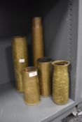 A selection of military brass ammunition shell cases of various sizes