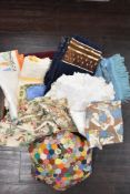 A selection of retro textiles and fabrics including patchwork cushion and table cloths etc