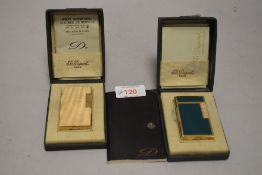 Two fine and luxury St. Dupont cigarette lighters by including guilloche worked case in yellow metal