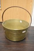 A vintage brass and cast jam pan
