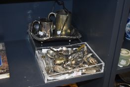 A selection of loose cutlery and serving spoons with tankards