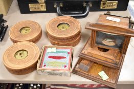 A late Victorian Kinora filp film viewer oak framed with glass viewer along with four Kinora films