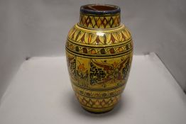 A mid century Moroccan studio pottery vase having mustard ground with decoration