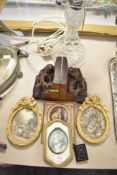 A pair of German carved wood musician themed book ends and gilt framed prints