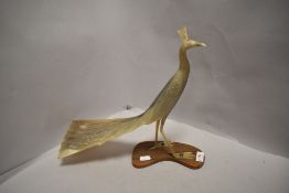 A mid century hand carved horn figure of an exotic bird or a peacock