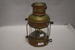 A 20th century copper and brass ships light or lantern, with label reading anchor