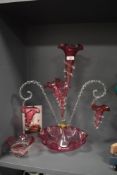 A Victorian cranberry glass centre piece epergne, having twist stems with cranberry well and hanging