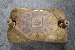 A traditional camel stool having tooled leather top