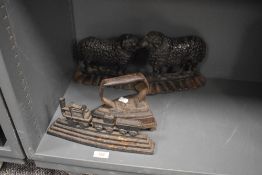 Two Victorian cast iron Sheep or Ram door stops and a similar train example with an iron