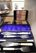 A selection of cased cutlery and flatware including two serving sets and boxed knives