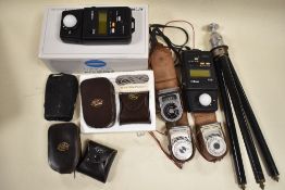 A box containing a selection of Light/ exposure meters and Invercones including Western Master V,