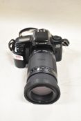 A Canon EOS 1000F camera with Sigme Zoom 75-300mm 1,4-5,6 lens in a soft carry case