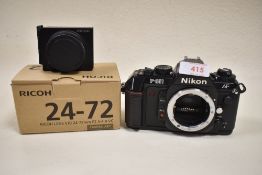 A Nikon F501 AF camera body with a boxed Ricoh 24-72 camera unit