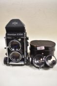 A Mamiya C330 camera with Mamiya Sekor 80mm lens and 65mm lens