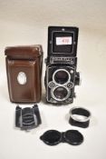 A Rolleiflex Reflex camera with Carl Zeiss Planer 75mm f3,5 lens in leather cover