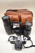 A Pentax MX camera with SMC Pentax-M 50mm 1,7 lens, SMC Pentax-M 28mm 2,8 lens, a Bell & Howell 70-