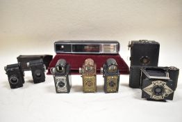A selection of miniature cameras. Three Coronet Midget bakelite cameras, an Ensign Midget, two