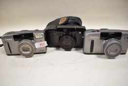 Three Canon cameras, a Canon Z115 Sureshot and two Canon Z135 Sureshot