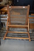 An adjustable ratchet foot or gout stool beech frame with rattan seat