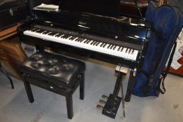A Roland HP109 digital grand piano and adjustable stool