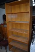 A traditional golden oak library or commercial bookcase having deep shelves