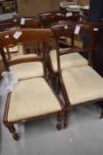 A set of four Victorian mahogany rail back dining chairs, signs of some past worm
