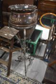 A 19th Century copper jardiniere on wrought metal frame