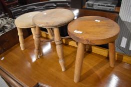 Three traditional milking style stools with oak and ash frames
