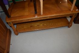 A reproduction coffee table in a light stain, classical style