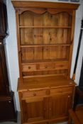 A natural pine dresser of narrow proportions